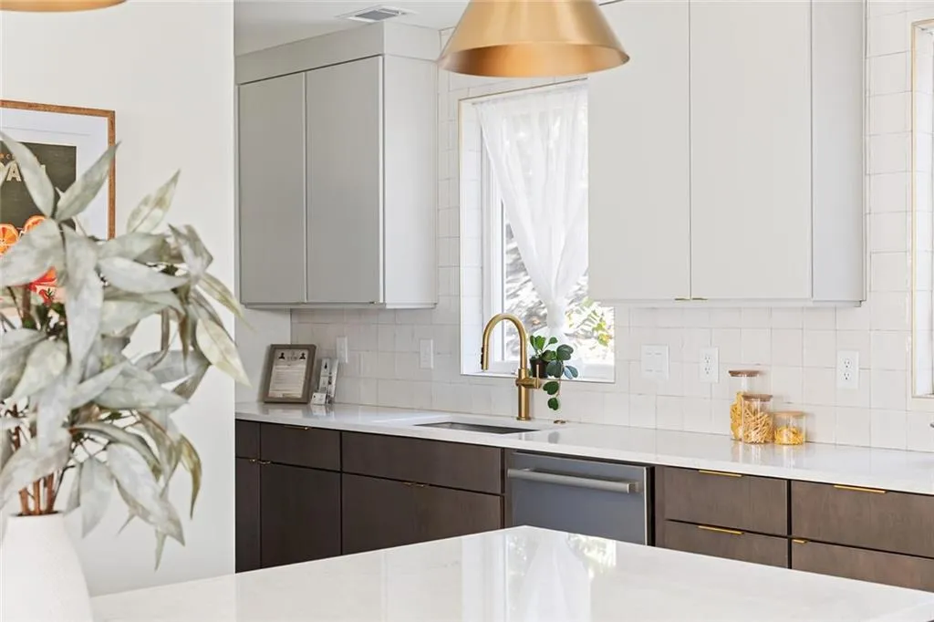 Kitchen with dishwasher, modern cabinets, and white cabinetry
