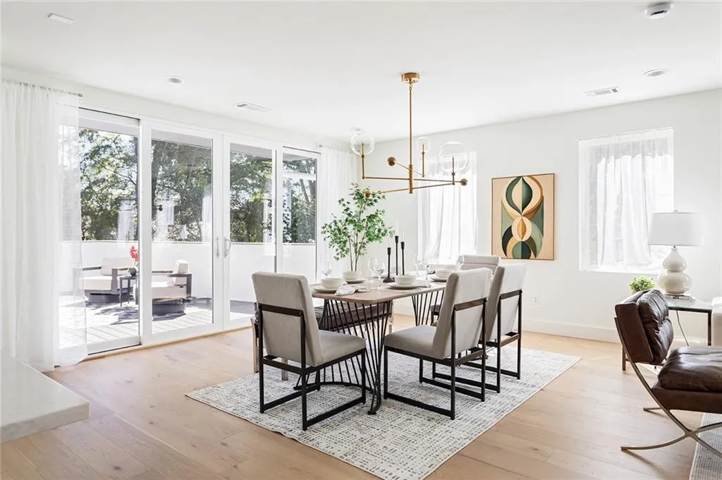 Dining space with light wood-type flooring and a chandelier