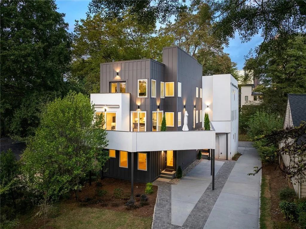 Modern home featuring board and batten siding and driveway