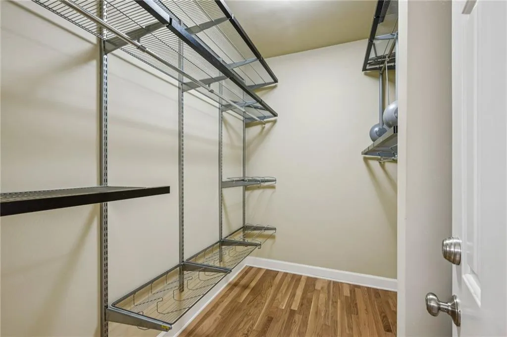 Walk in closet featuring light wood-style floors