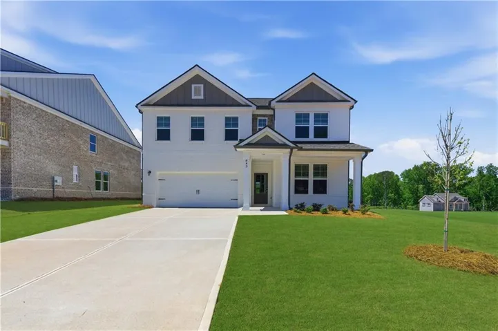 Two-story residence featuring a white painted brick facade and dark trim accents