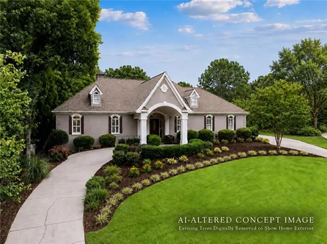 Single-story stucco exterior with dormer windows, a covered entry, and a paved driveway