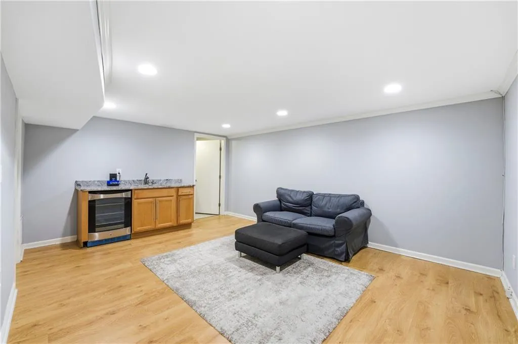 Media or Gaming Room with built-in wet bar adjoining flex space and laundry room