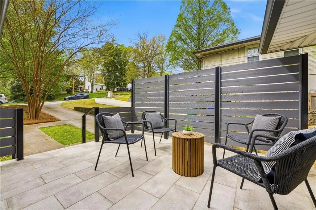 Welcoming front patio with a modern privacy screen and usable outdoor living space. Set on a large, flat lot, the home also benefits from a full terrace-level basement with daylight and convenient backyard access.