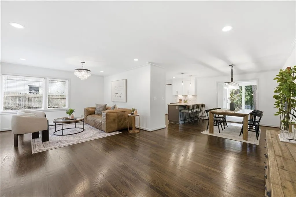 Spacious, open-concept living area with hardwood floors, recessed lighting, and abundant natural light. The layout flows easily into the dining and kitchen areas, offering flexibility for both daily living and entertaining.