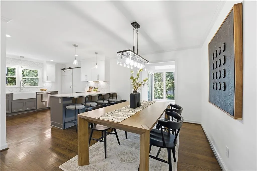 Open kitchen design that connects seamlessly to the main living areas, featuring quartz countertops, a full Thermador appliance package with built-in refrigerator, and subtle under-cabinet lighting that highlights the workspace while maintaining a clean, modern aesthetic.