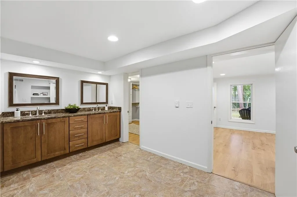 Spacious, updated primary bath featuring an oversized walk-in shower and heated floors for added comfort. Clean finishes and a well-proportioned layout create a functional, spa-like space designed for daily use.