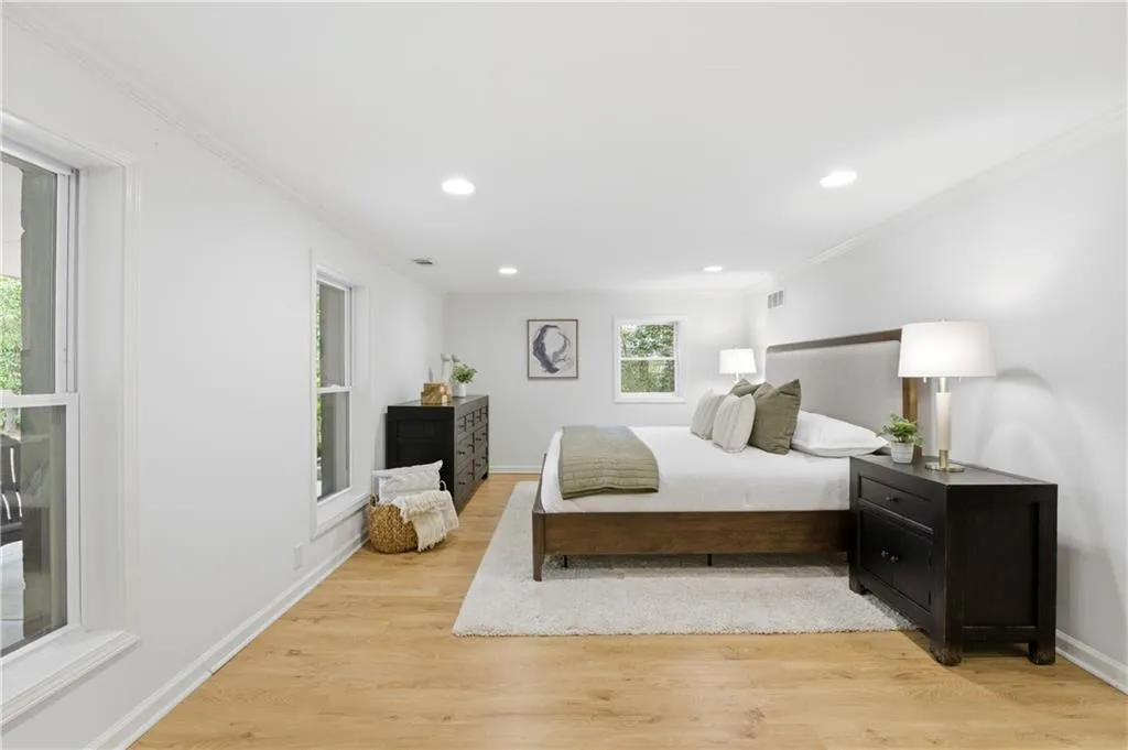 Primary BedroomGenerously sized primary bedroom with hardwood floors, recessed lighting, and multiple windows bringing in natural light. Clean lines and a neutral palette create a calm, comfortable retreat.