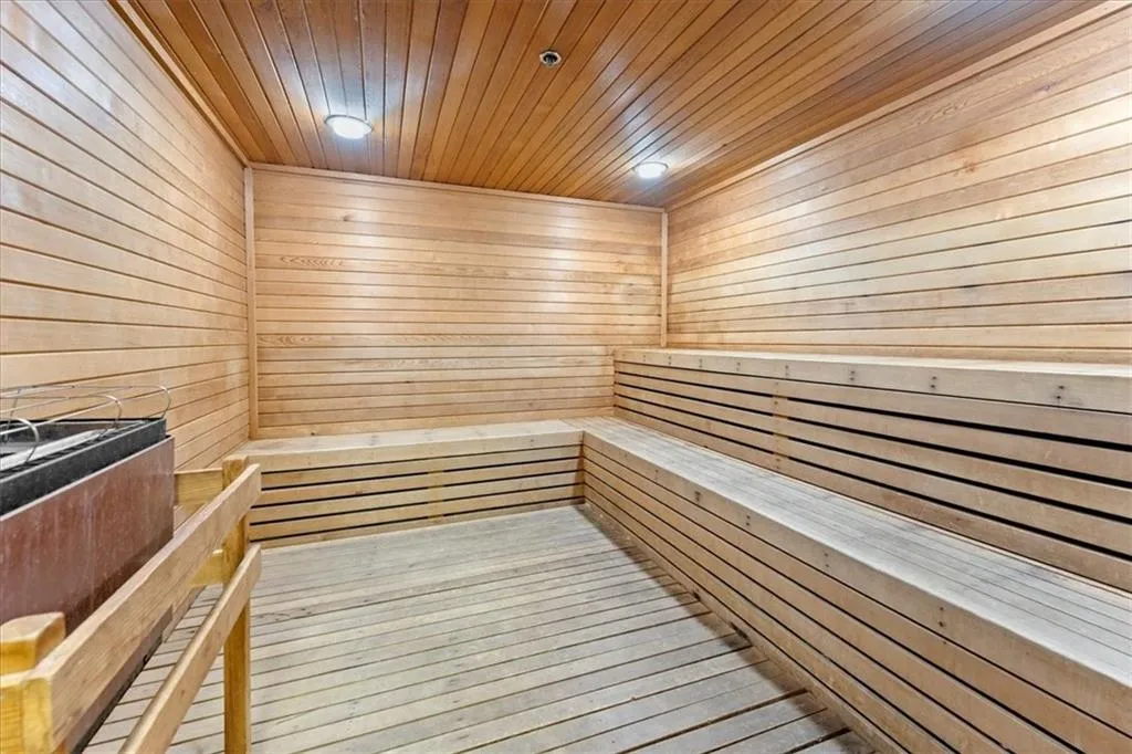 Relaxing sauna / steam room featuring wood ceiling and wood walls