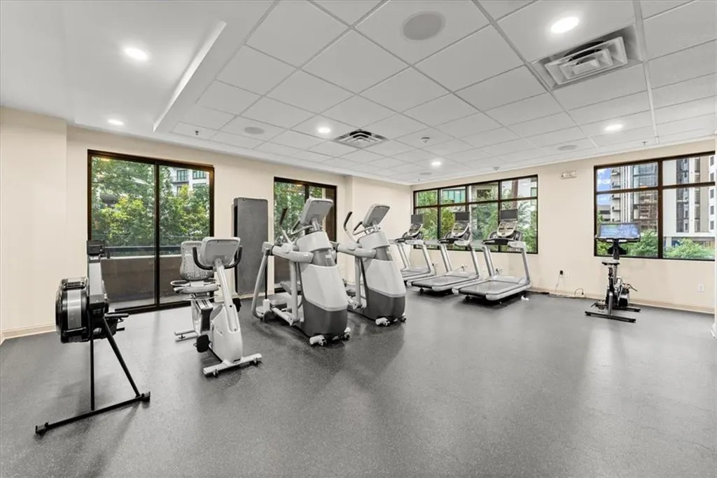 Exercise room featuring recessed lighting and a drop ceiling