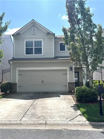 Two-story residence featuring light siding and a prominent front-facing gable