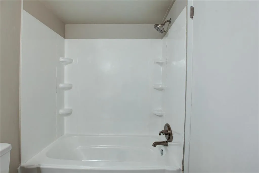 Bathroom with tub / shower combination and toilet