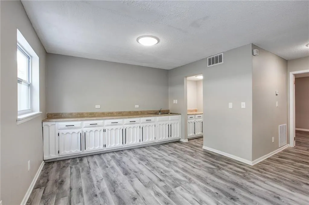 Spare room with light wood-style flooring and a textured ceiling