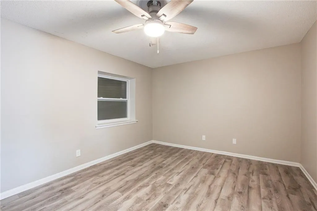Spare room with light wood-type flooring and a ceiling fan