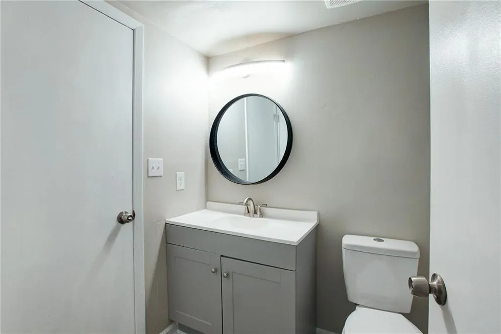 Half bathroom featuring vanity and toilet