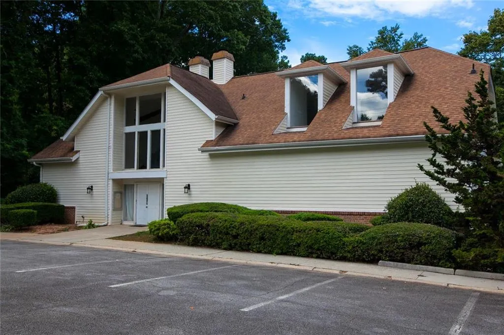 View of property with uncovered parking