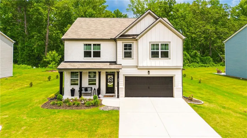 Modern farmhouse exterior with white siding and dark trim accents