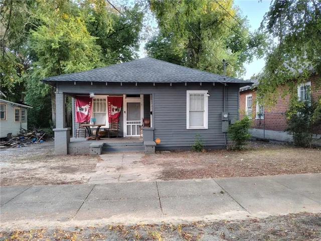 View of front of property with covered porch and roof with shingles