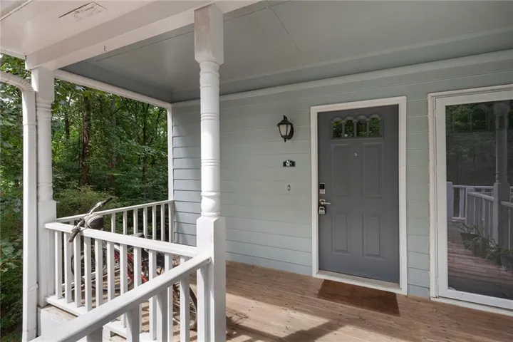 Covered porch entry featuring wood-finish flooring