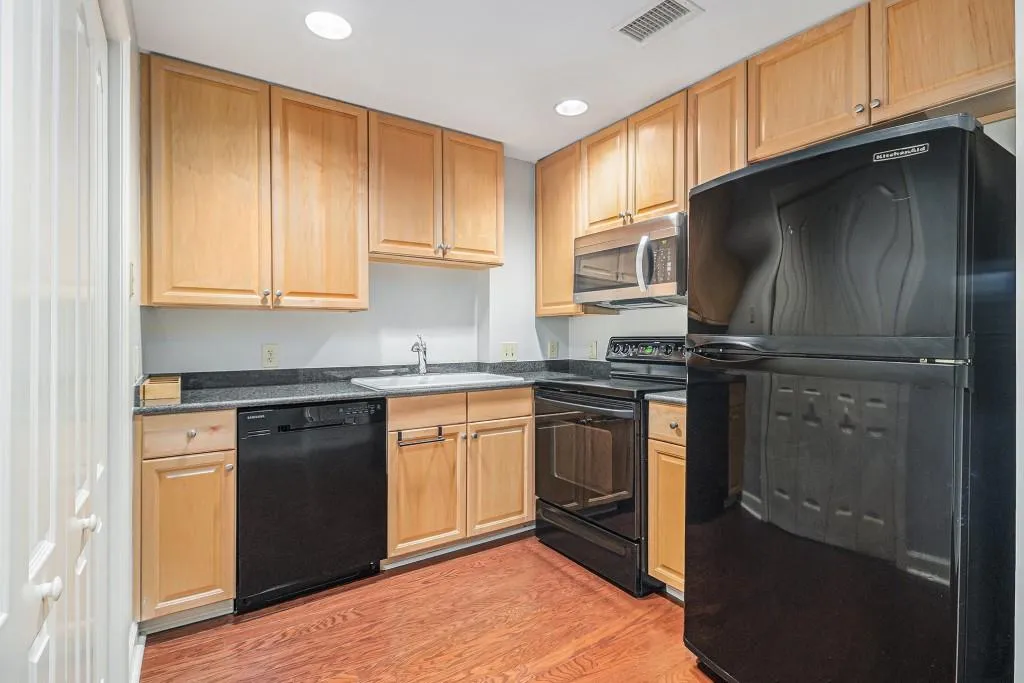 The Kitchen features elegant Maple Cabinetry and Granite Counters, offering a functional and stylish space for cooking and entertaining.