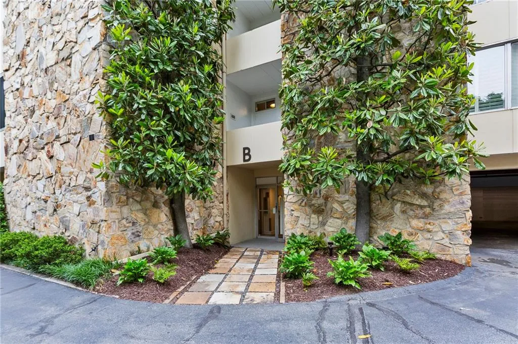 Secured building entrance featuring stone siding