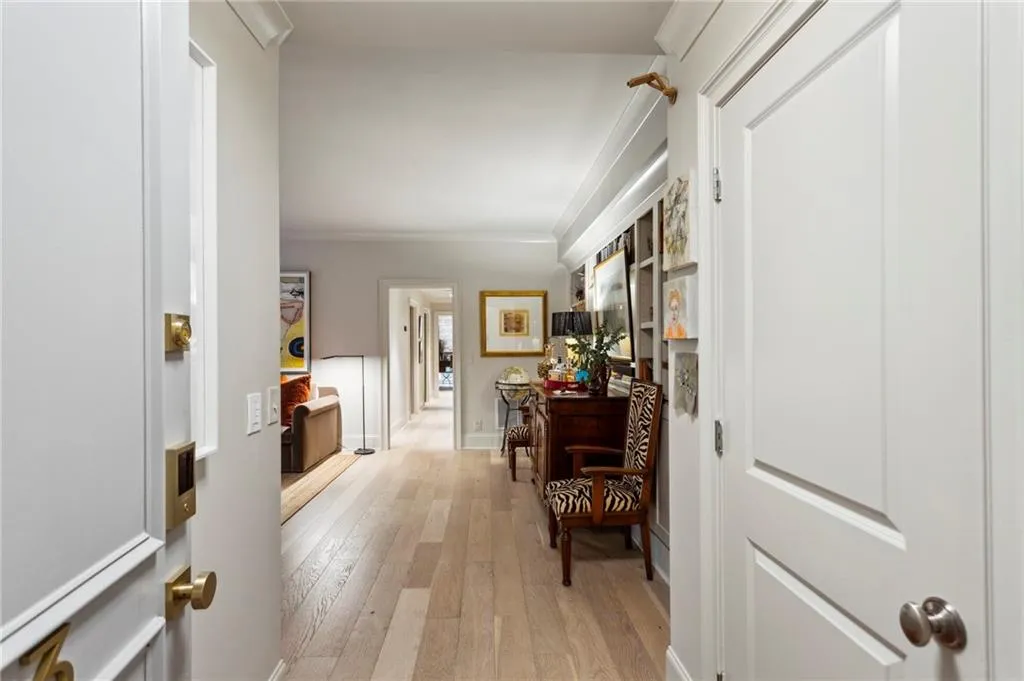 Foyer featuring ornamental molding and light wood-style flooring