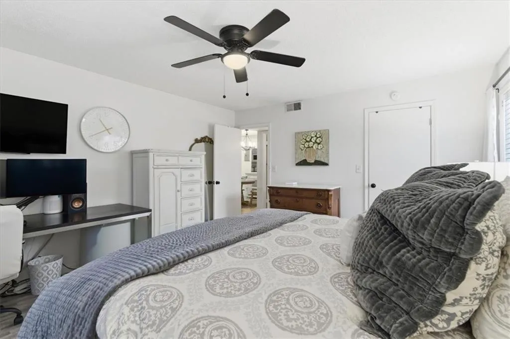 Bedroom with a ceiling fan and an office area
