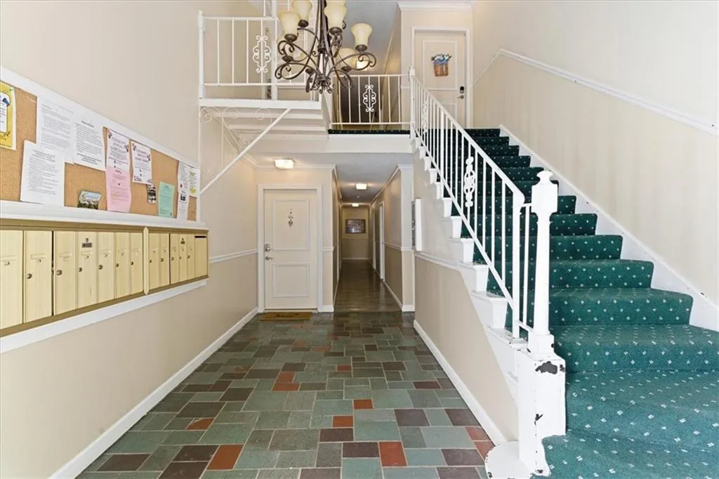 Foyer entrance featuring mail area and a chandelier
