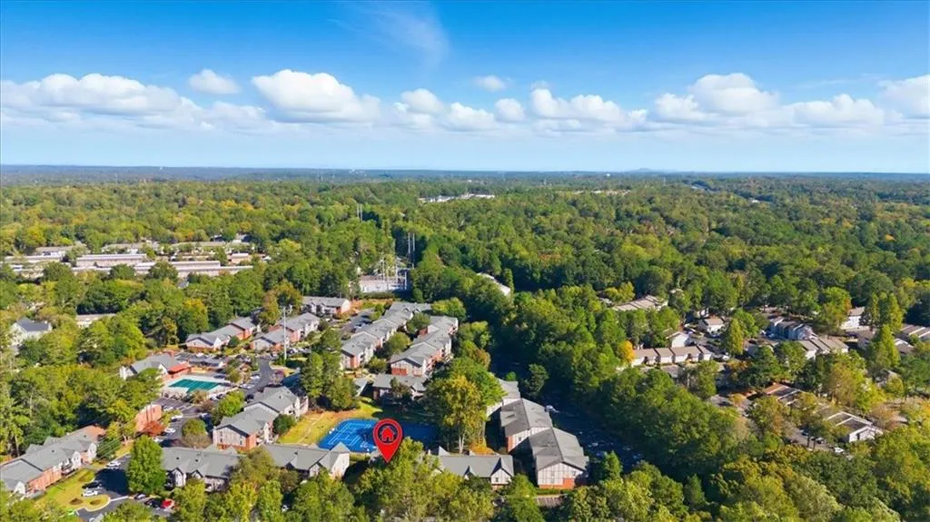 View of property location featuring a forest