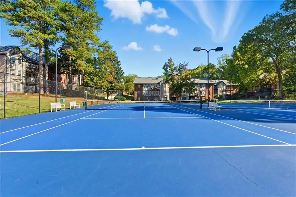 View of tennis court featuring community basketball court and a residential view