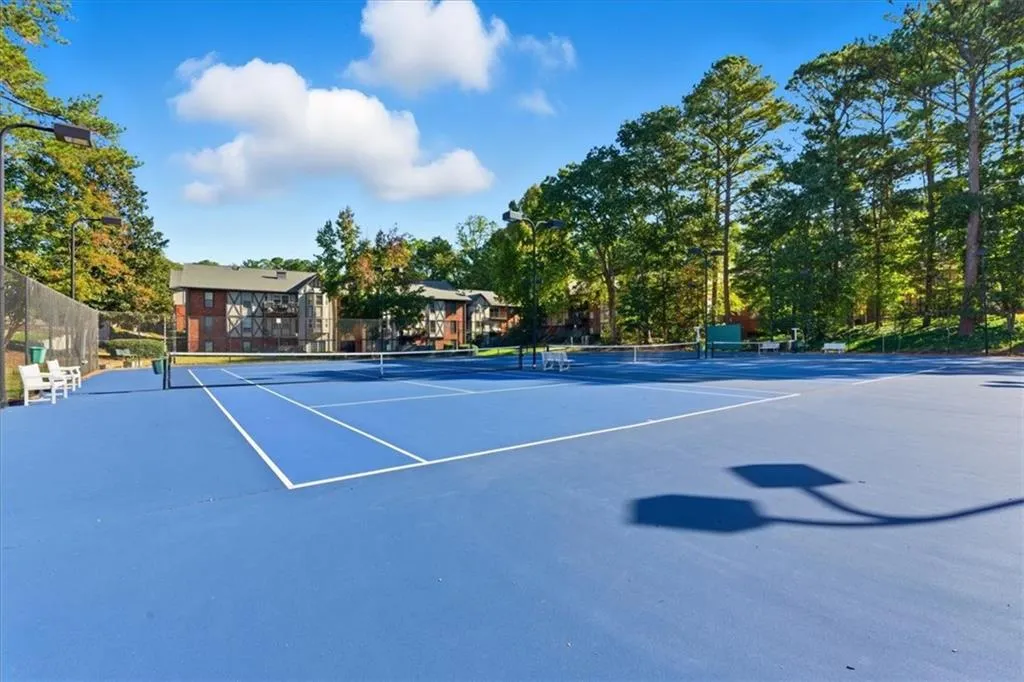 View of tennis court with community basketball court