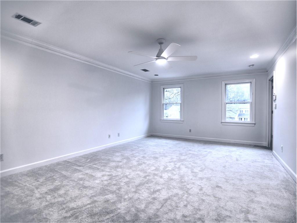 Primary Bedroom  featuring crown molding, light carpet, and ceiling fan