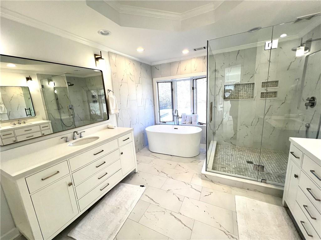 Newly renovated primary bathroom with a free standing tub and a Glass Shower.