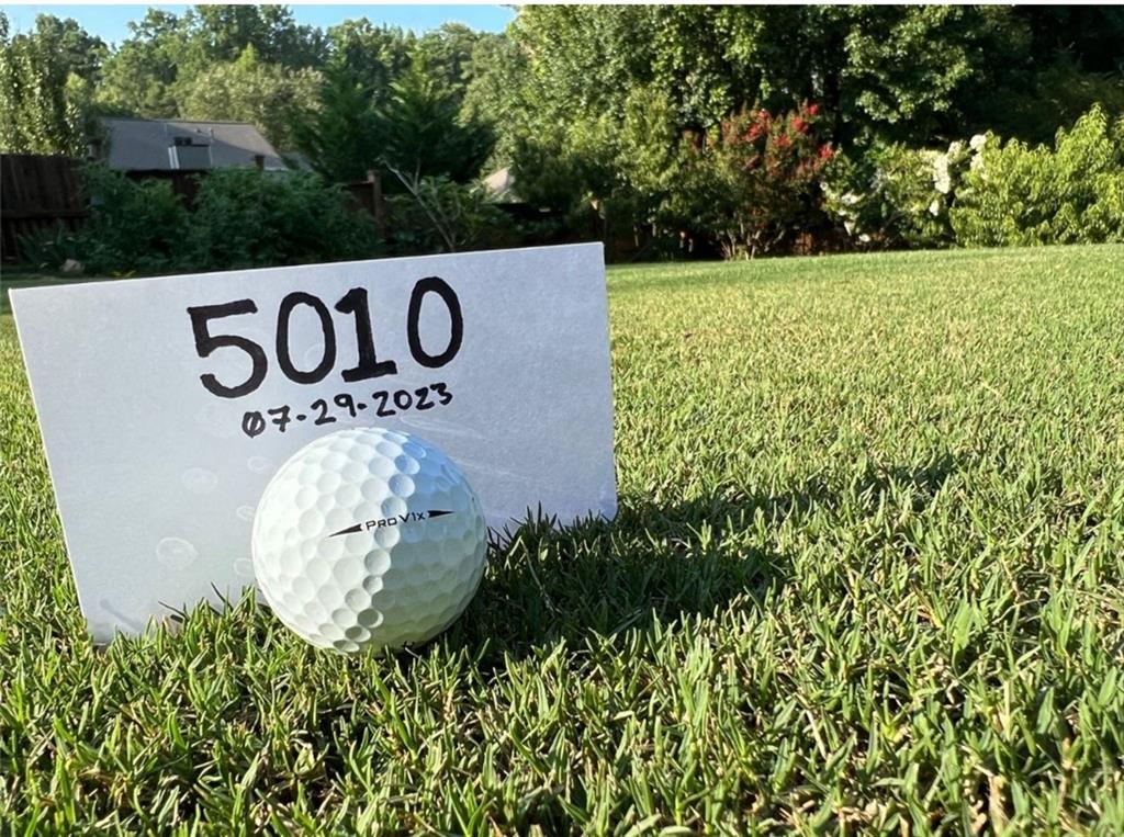 Community / neighborhood sign with a yard