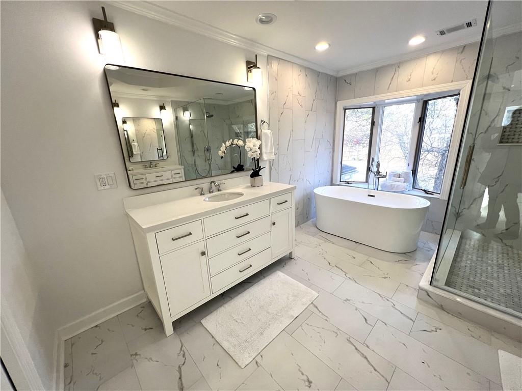 Bathroom with separate shower and tub, tile floors, and vanity