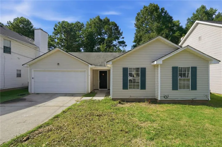 Single-story exterior with siding, a gabled roof, attached garage, front entry door, and decorative window shutters
