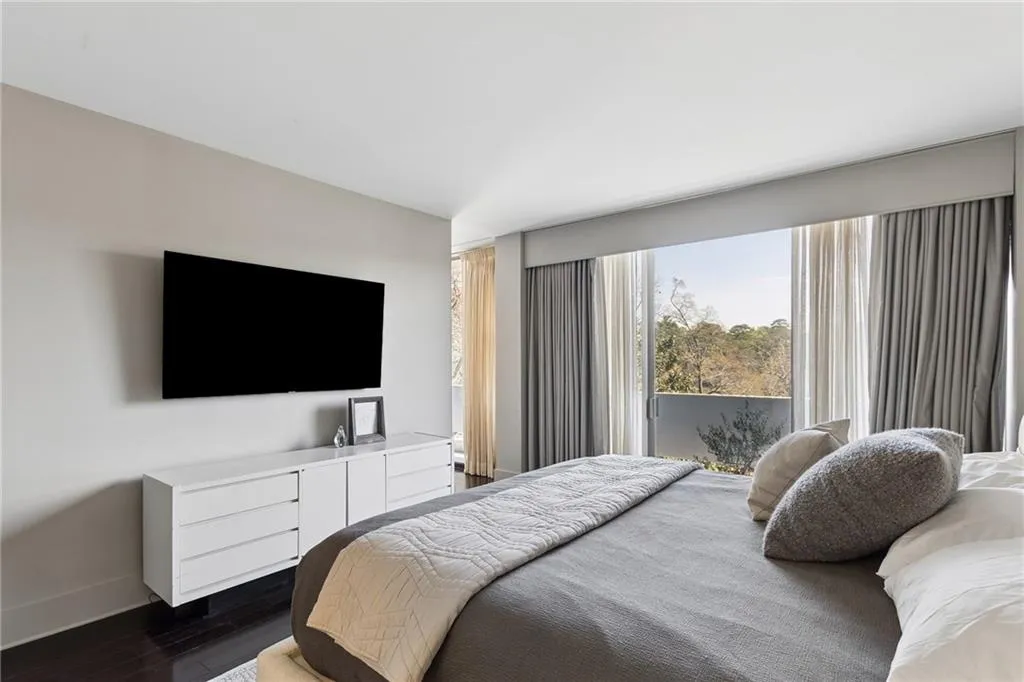 Bedroom with dark wood-type flooring and baseboards