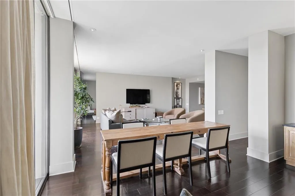 Living area with baseboards and dark wood finished floors
