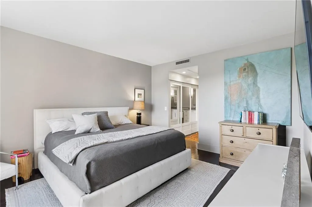 Bedroom with dark wood-style floors and baseboards