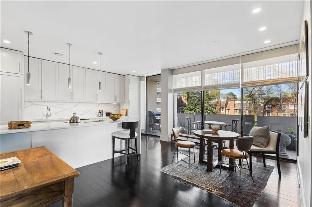 Dining space with dark wood-style floors and recessed lighting