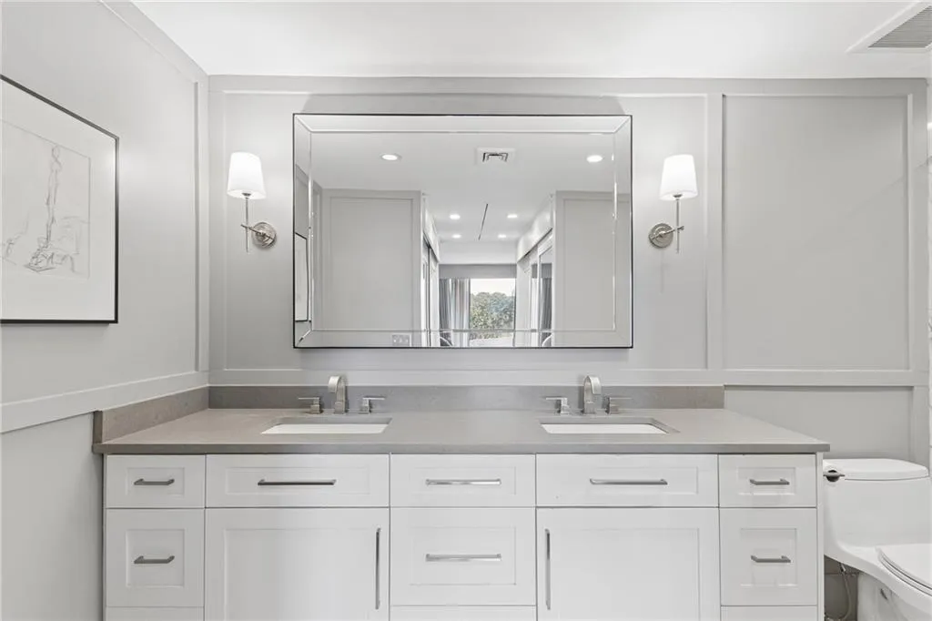 Full bath featuring double vanity and recessed lighting