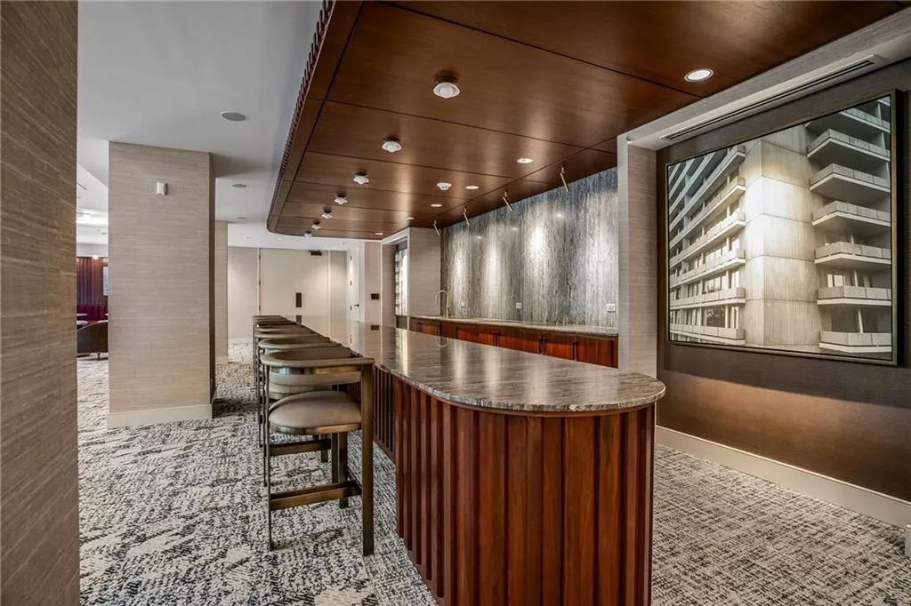 Bar area with dark stone counters and modern cabinets