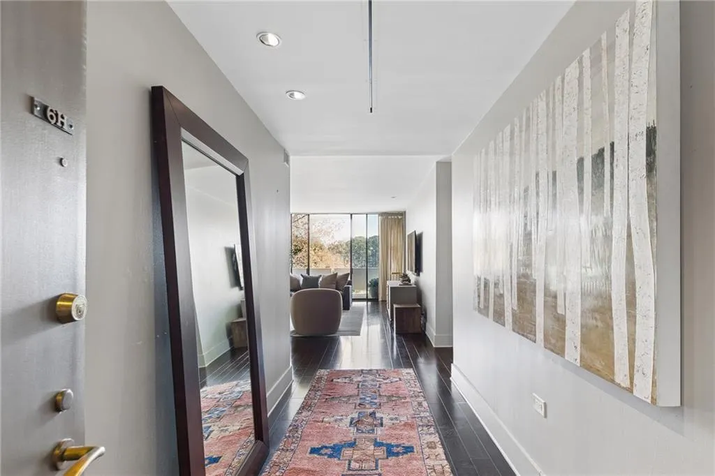 Corridor with baseboards and dark wood-style floors