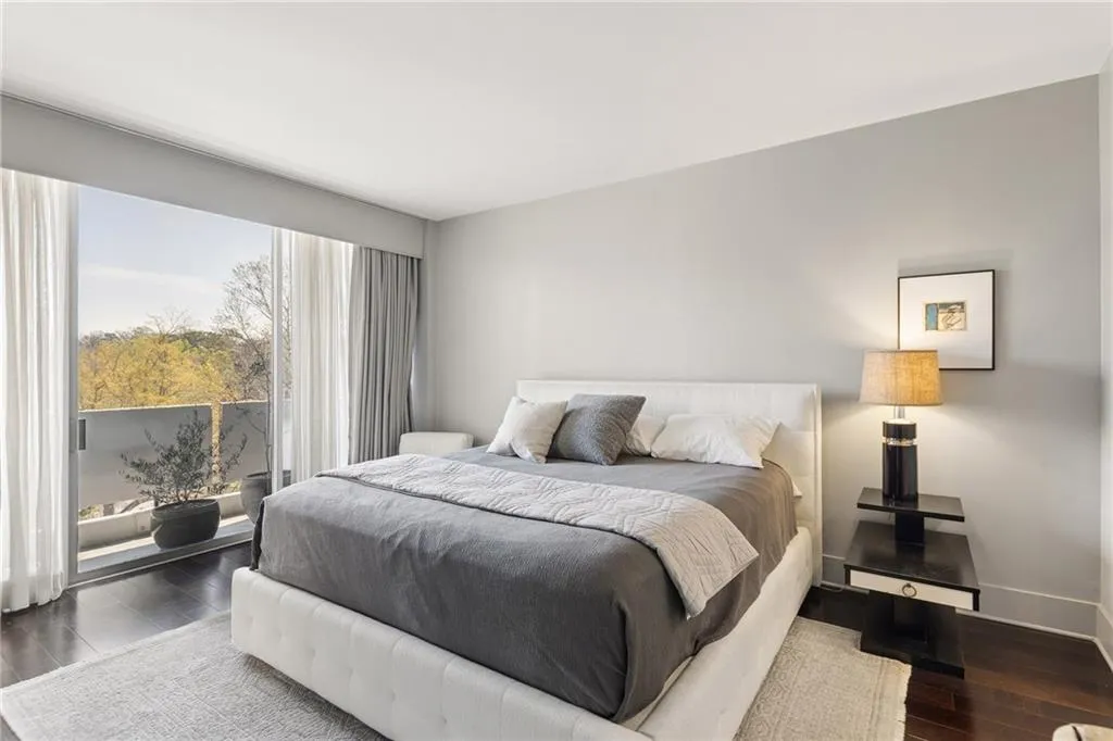 Bedroom with access to outside and dark wood finished floors