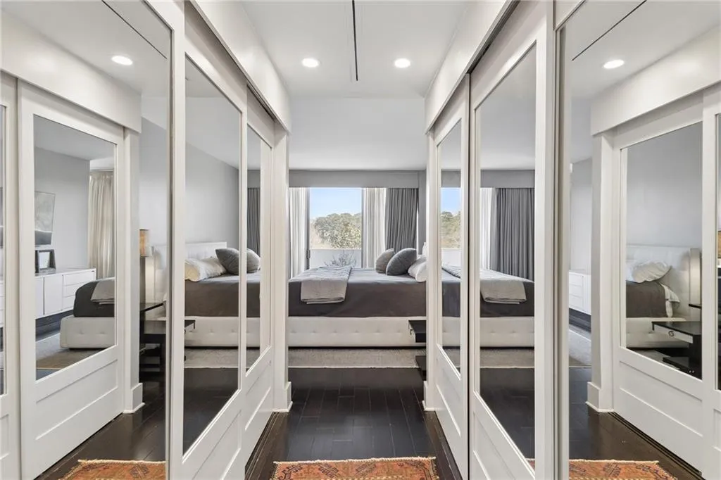 Walk in closet featuring dark wood finished floors