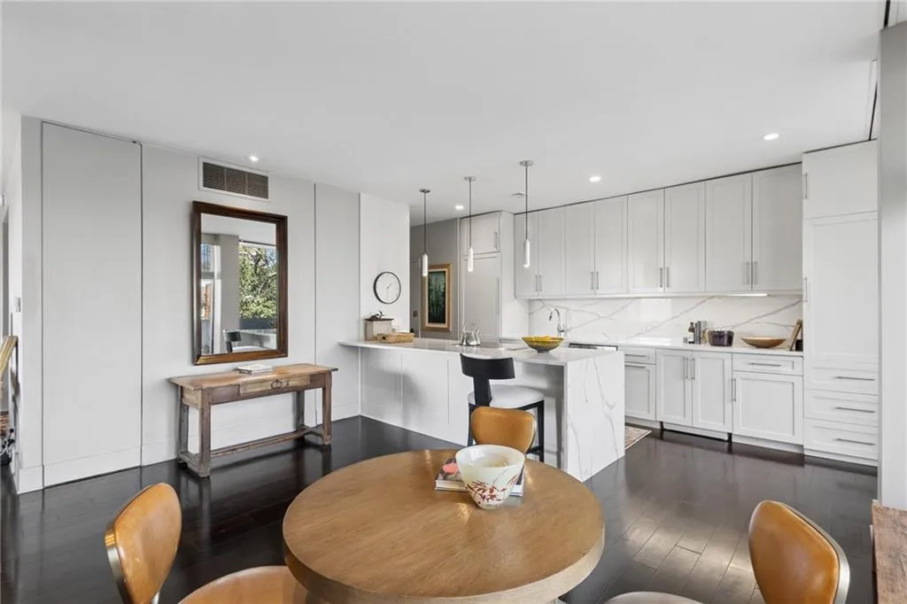Dining space with dark wood-type flooring and recessed lighting