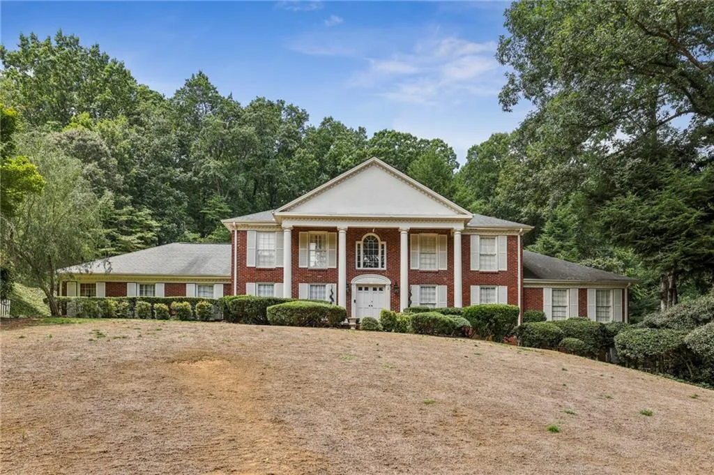 Greek revival house featuring brick siding