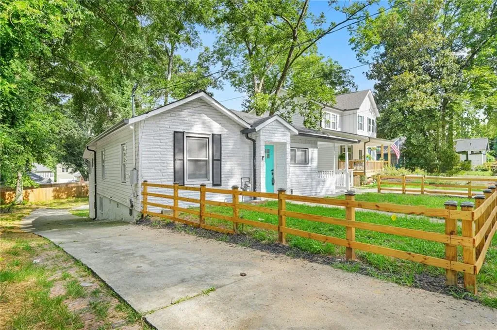View of front facade featuring a fenced front yard and driveway