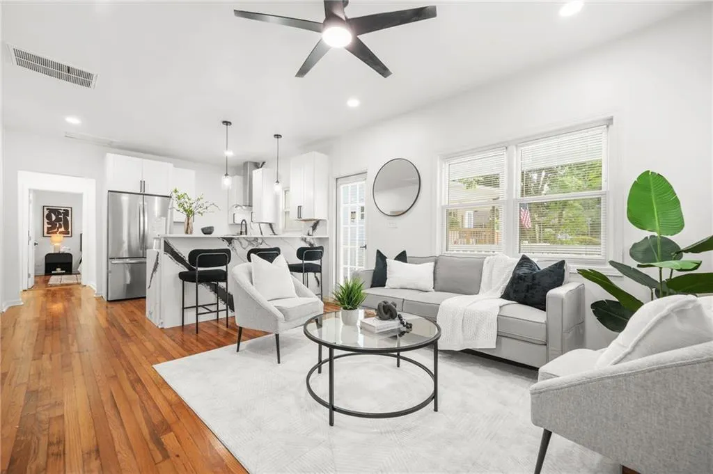 Living area featuring a ceiling fan, light wood-style floors, and recessed lighting