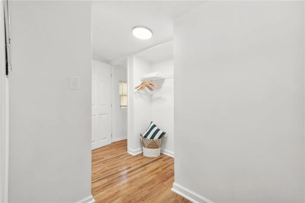 Walk in closet with light wood-style floors